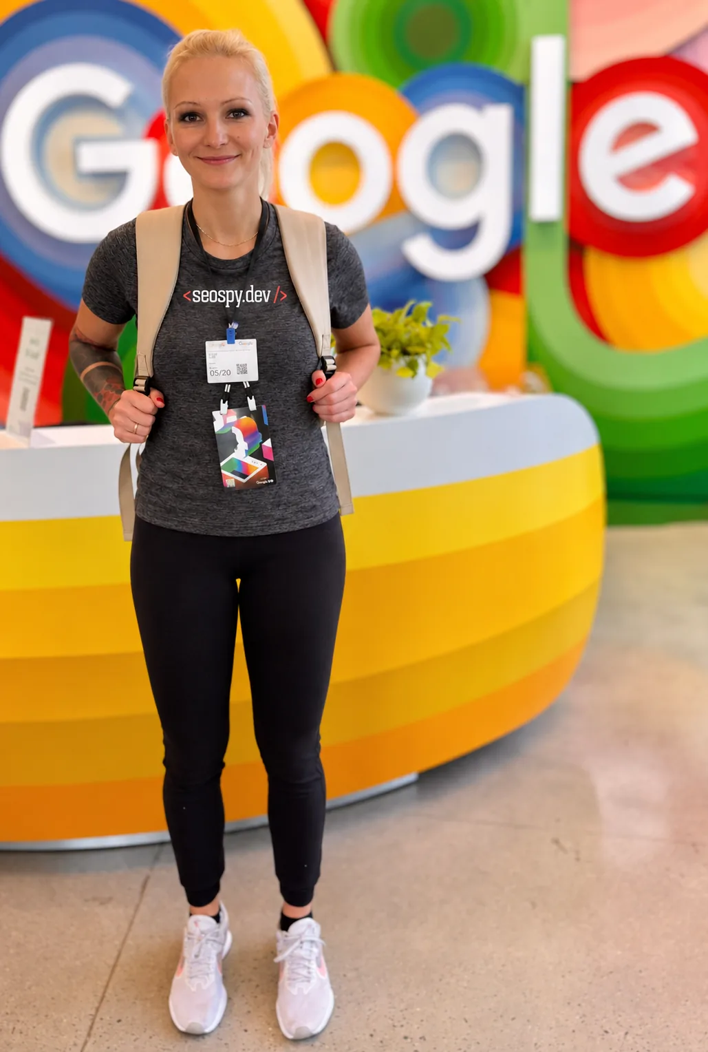 Olga Zarr, SEO consultant, standing in front of a colorful Google display.