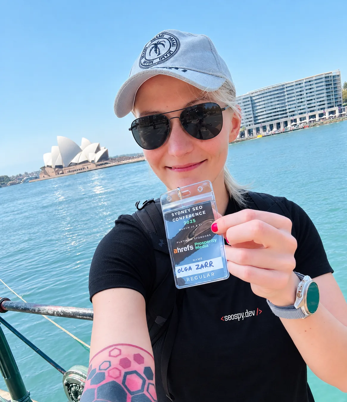 Olga Zarr, SEO consultant, beside Sydney Harbour with the Opera House behind her.
